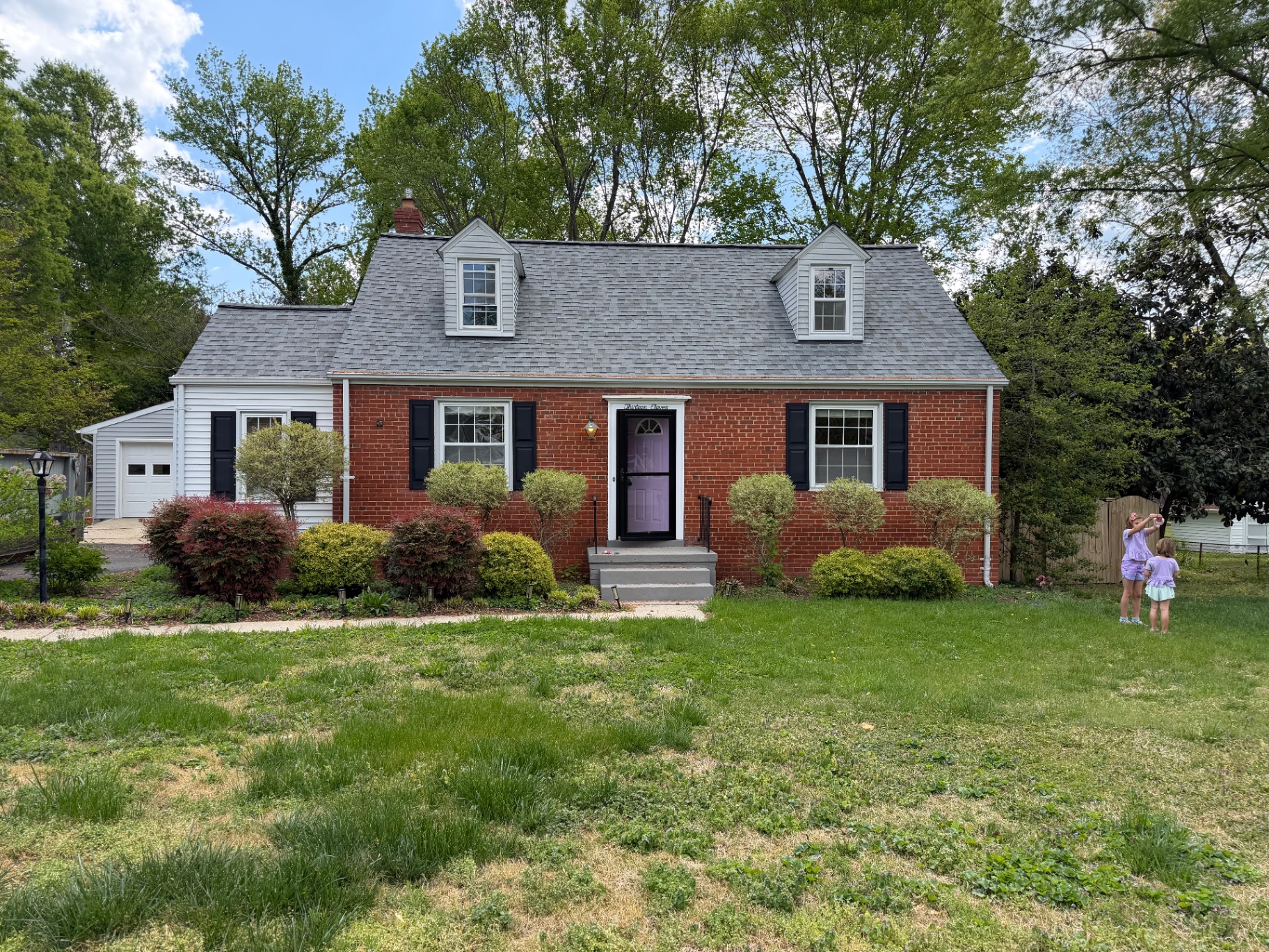 Before: front yard with rough lawn and less-defined landscaping